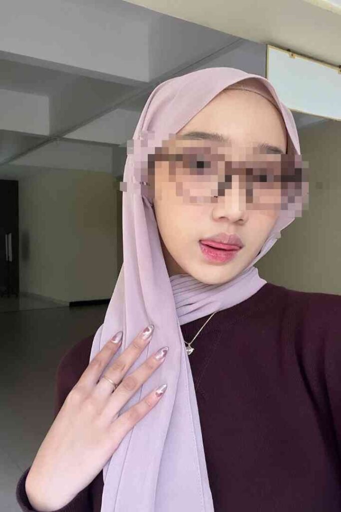 KL escort girl with hijab and sunglasses, offering local service in Malaysia.